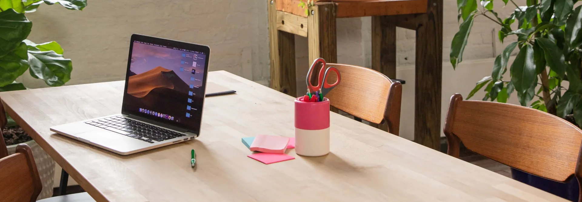 laptop on desk with sticky notes and coffee